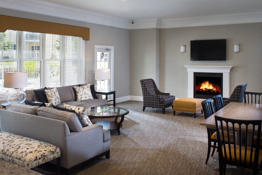 A living room with a fireplace and a television.