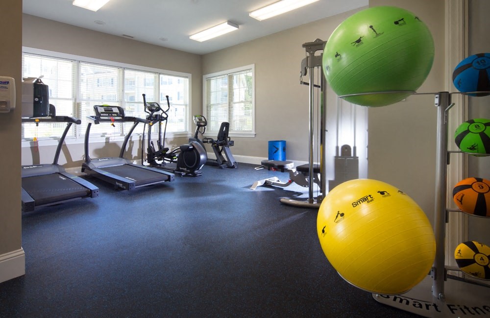 A gym with a yellow ball in the foreground.