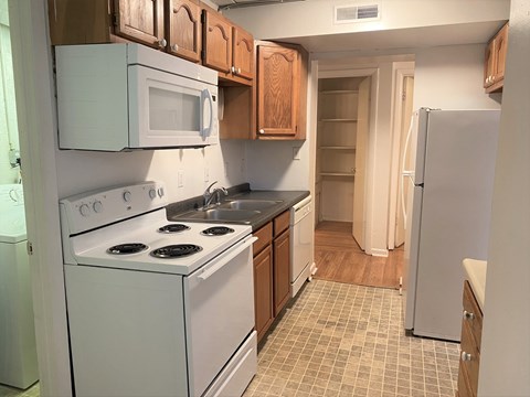 A kitchen with a white stove and white oven.