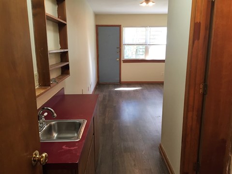 A kitchen with a sink and a window.