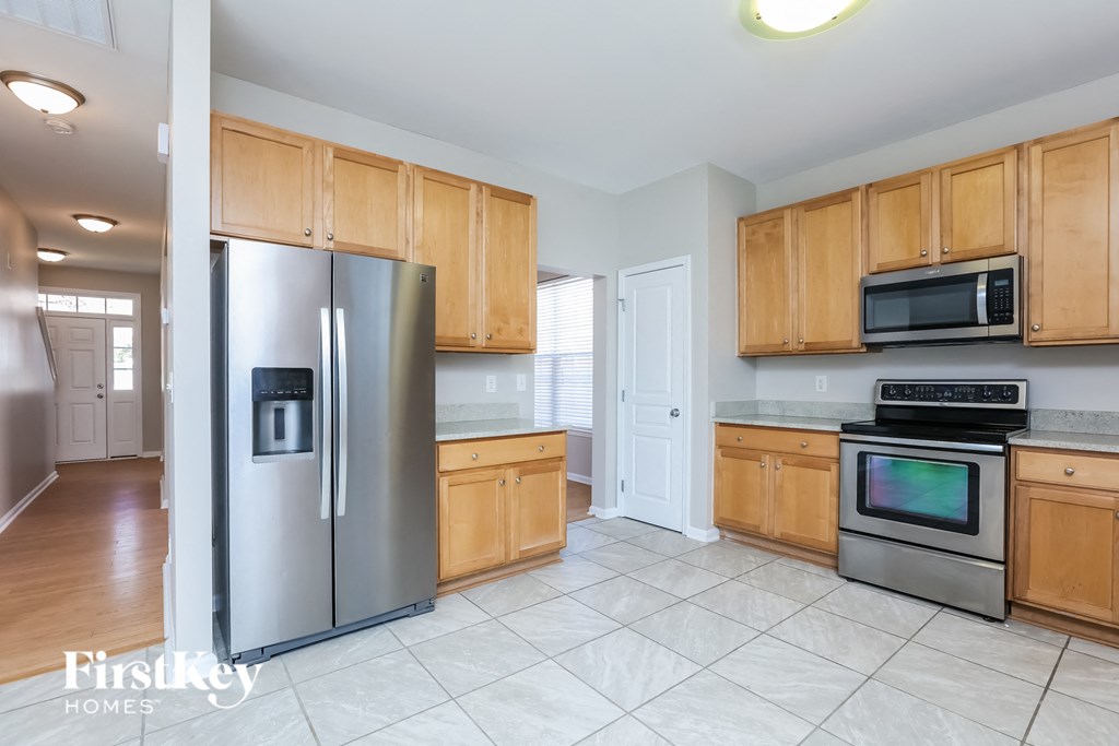 a kitchen with stainless steel appliances and wooden cabinets