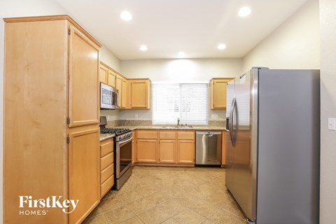a kitchen with wooden cabinets and stainless steel appliances