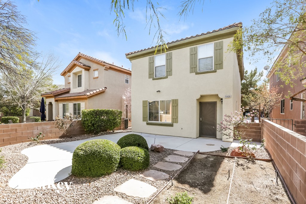 the front of a house with a yard and a sidewalk