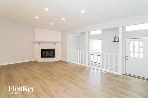 a living room with a fireplace and a white door