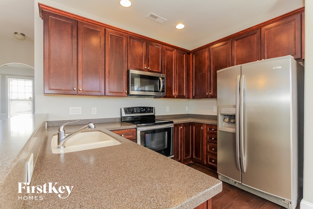 a kitchen with wooden cabinets and stainless steel appliances