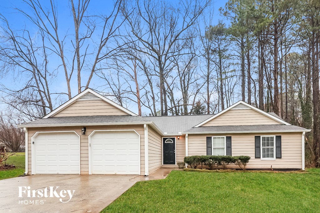 A two-story house with a garage is for sale.