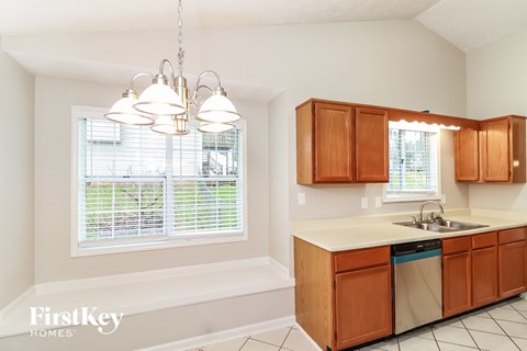 A kitchen with wooden cabinets and a white countertop.