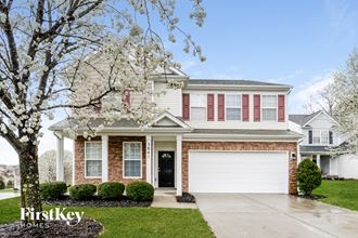 a home with a white garage door in front of it