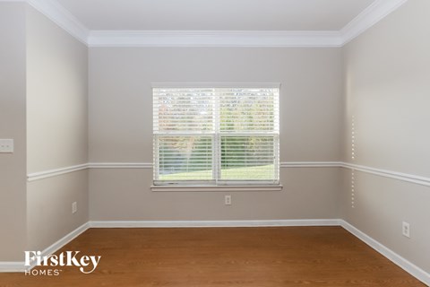 A room with a window covered in blinds.