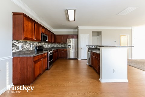 A kitchen with wooden cabinets and a white island.