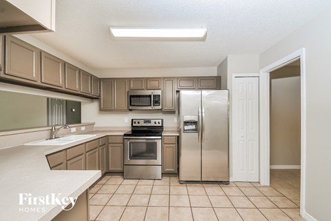 a kitchen with stainless steel appliances and wooden cabinets