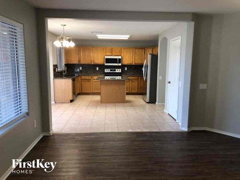 A kitchen with wooden cabinets and a black countertop.