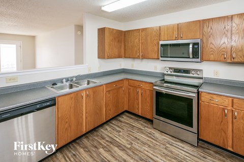 A kitchen with wooden cabinets and stainless steel appliances.