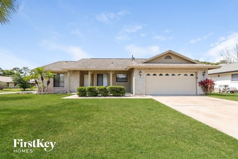 a home with a lawn and a garage
