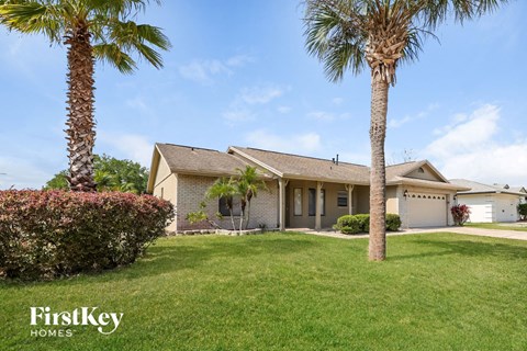a house with palm trees in front of it