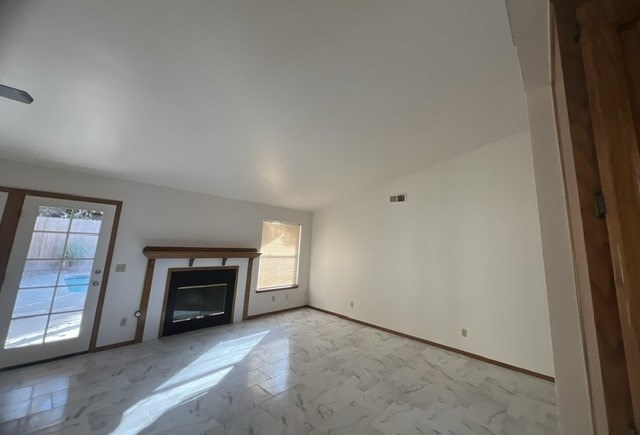 an empty living room with a fireplace and white walls