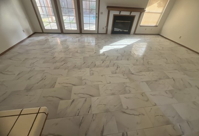 a living room with a marble floor and a fireplace