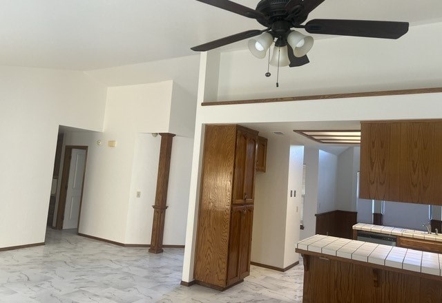 an empty living room with a ceiling fan
