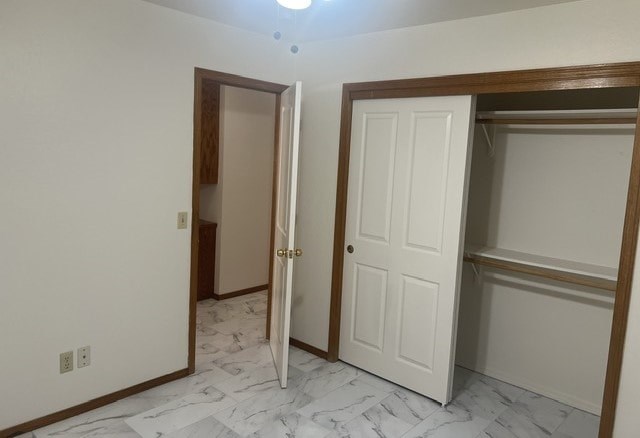 a room with a closet and two doors and a marble floor
