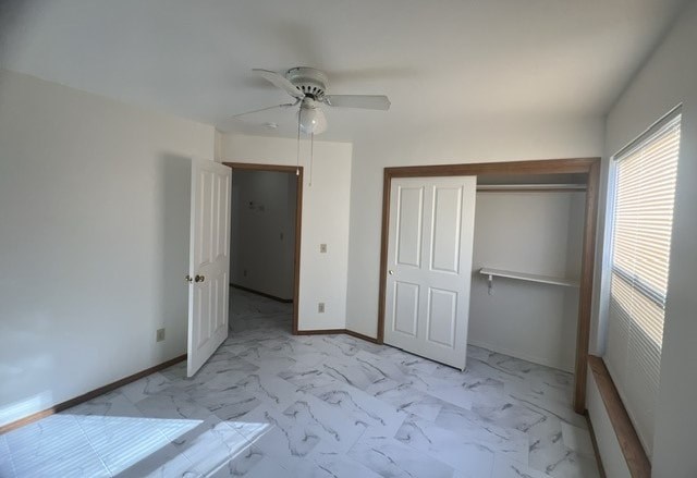 an empty room with a ceiling fan and a closet
