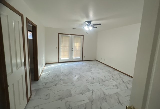an empty living room with a ceiling fan and a door