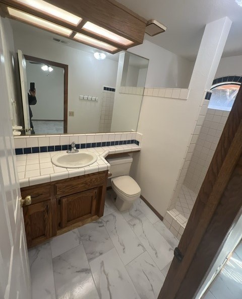 a bathroom with a sink toilet and a mirror