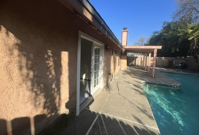 the side of a house with a swimming pool