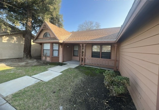 the front of a house with a yard and a sidewalk