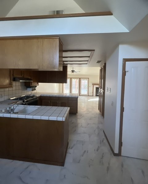 an empty kitchen with a stove and cabinets