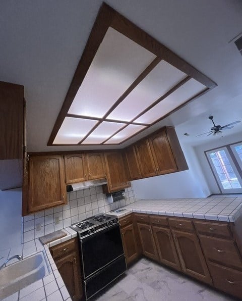 a kitchen with a window and a stove and cabinets