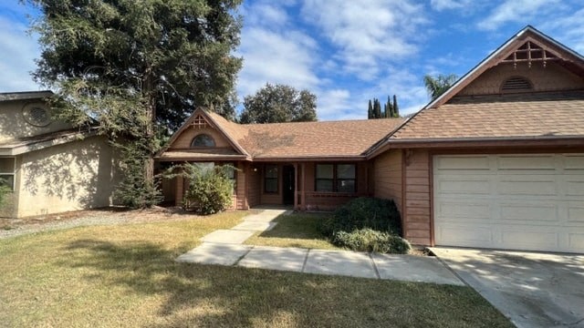 a house with a brown roof and a garage
