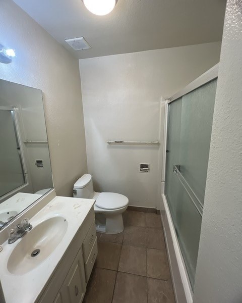 a bathroom with a toilet and a sink and a shower