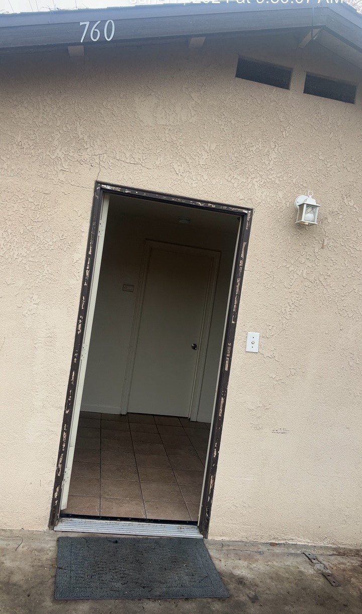 an open door of a building with a tile floor
