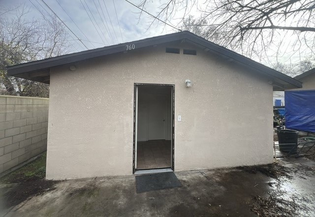 a small white building with a door