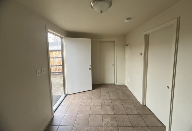 a living room with a tile floor and white walls