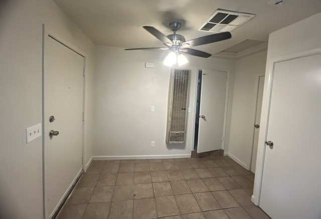 a living room with a ceiling fan and a door