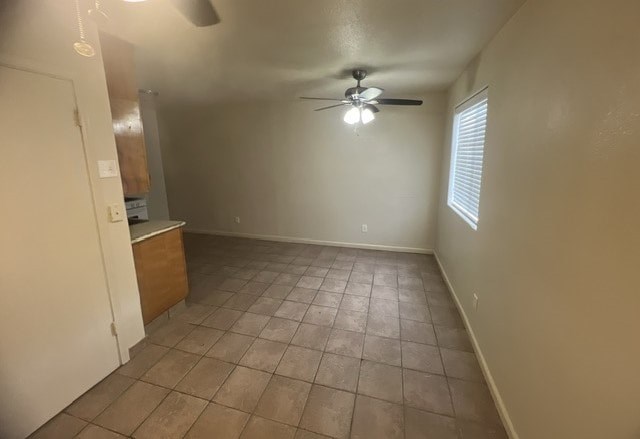 a empty living room with a ceiling fan