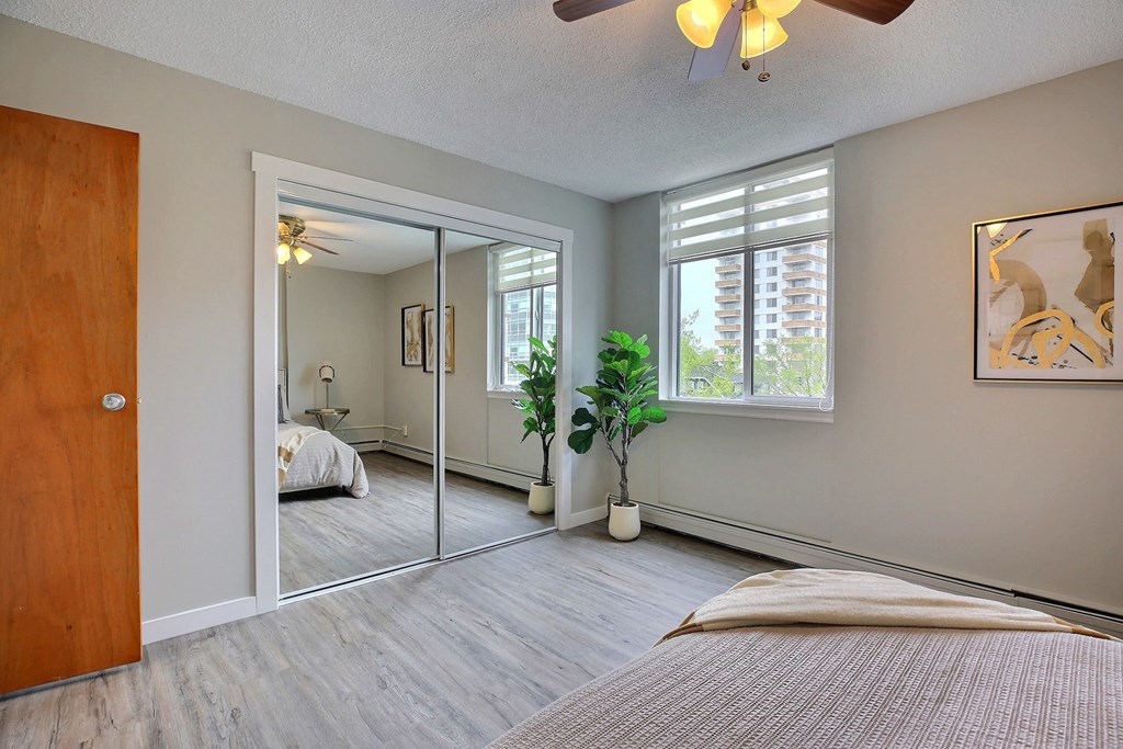 a bedroom with a large mirror and a bed