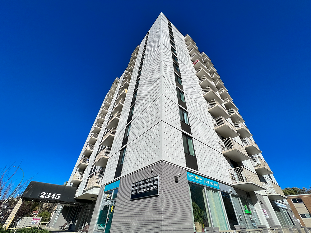 a tall building with a blue sky in the background