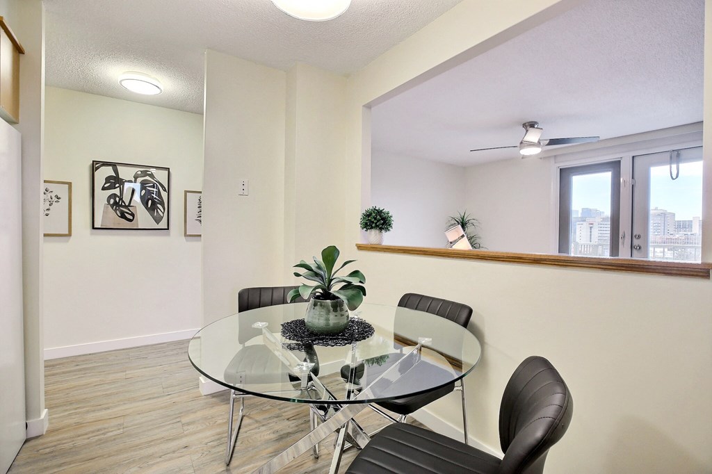 a dining room with a glass table and chairs