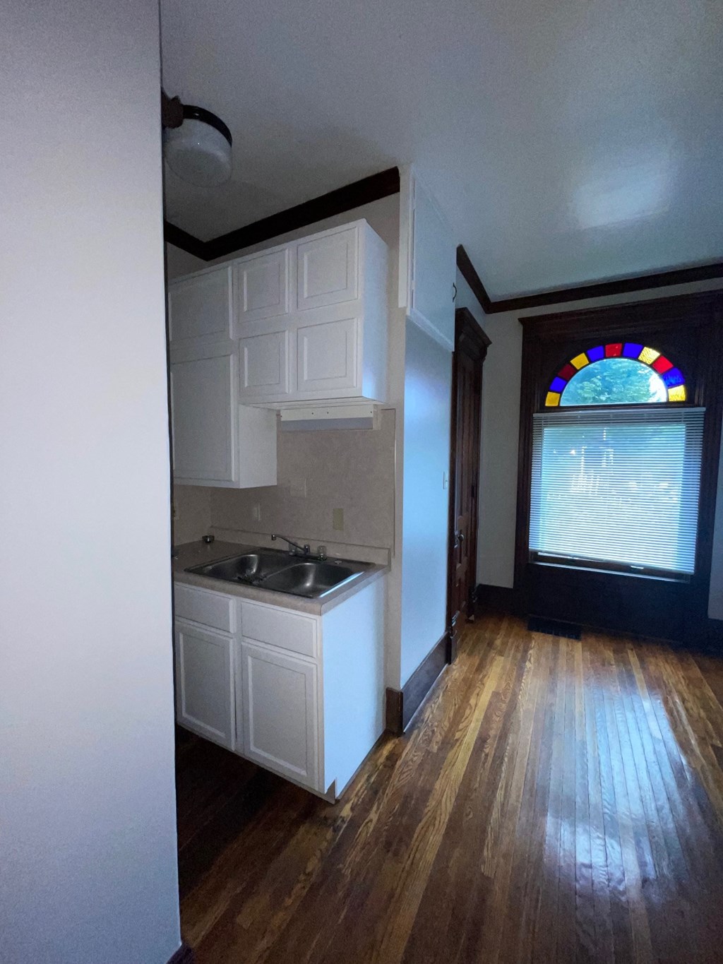 an empty kitchen with a sink and a window