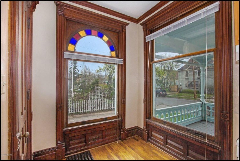 a living room with a large window and a balcony