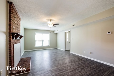 A room with a wooden floor and a ceiling fan.