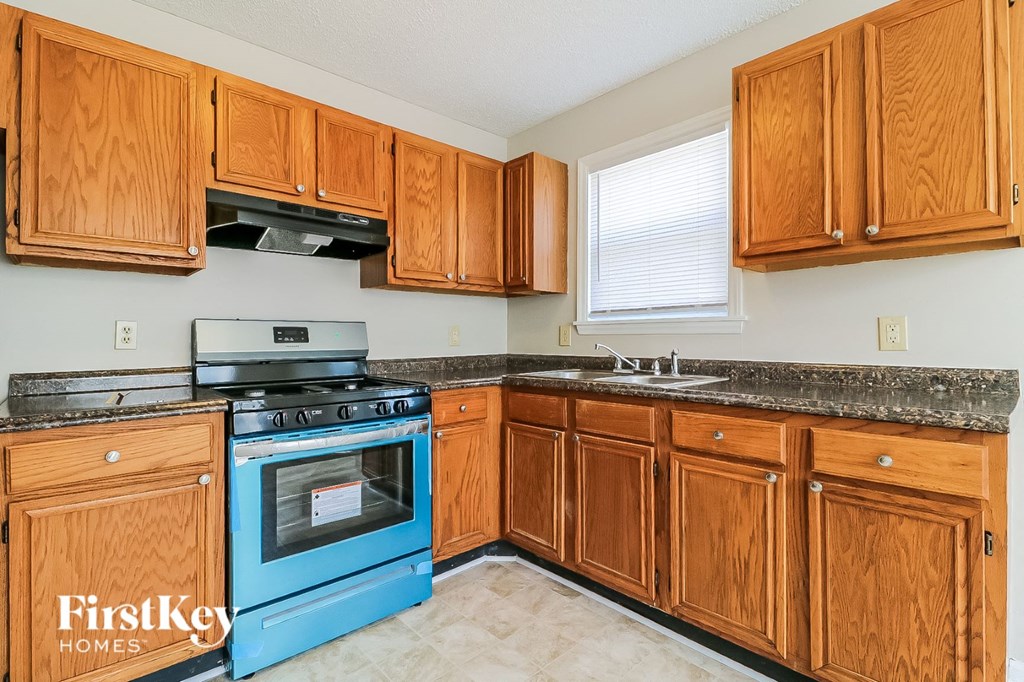 a kitchen with wooden cabinets and a blue stove and oven