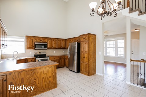 a kitchen with wooden cabinets and a stainless steel refrigerator