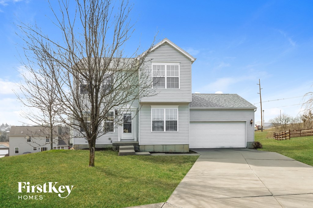 a white house with a sidewalk in front of it