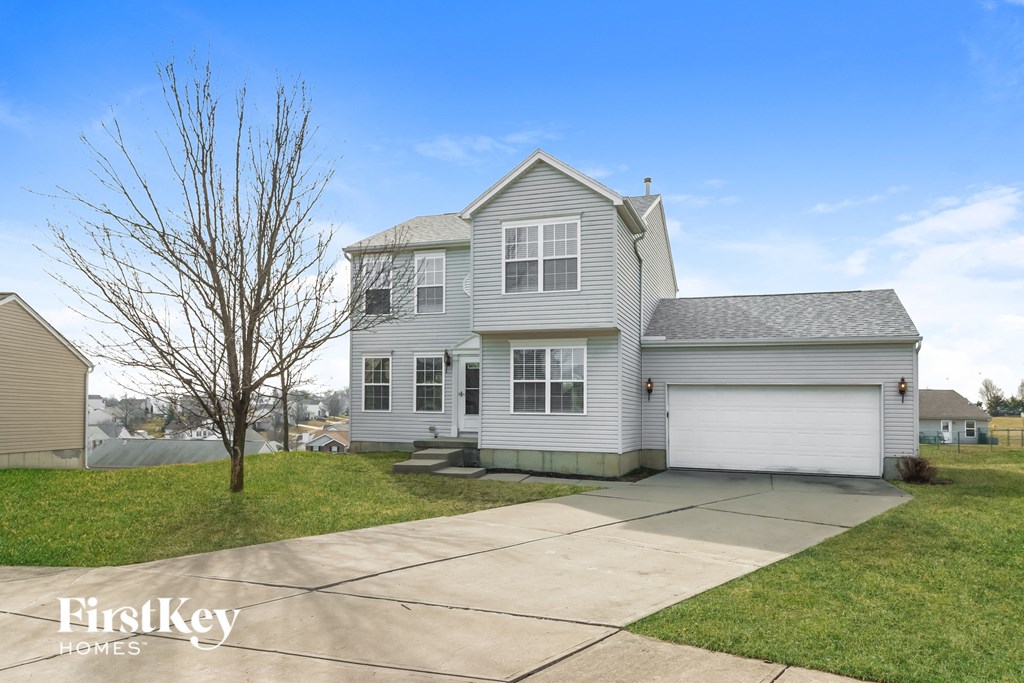 a white house with a sidewalk in front of it
