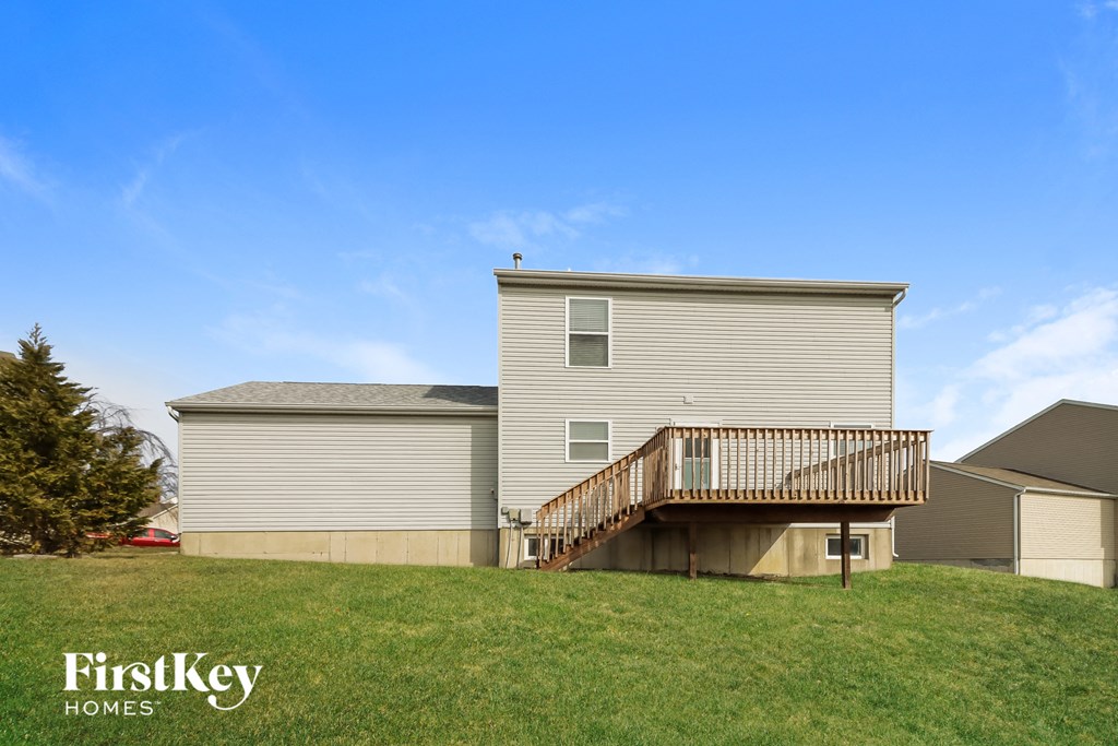 a house with a deck on top of a hill
