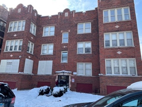 the front of a brick building in the snow