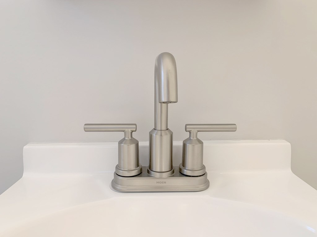 a close up of a sink faucet in a bathroom